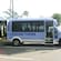 An accessible tour van with a vehicle lift and writing on the side that says ‘Leisure Tours’